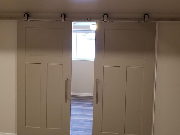 Lower level bedroom #3 entrance. Cute rolling barn door with high quality hardware
