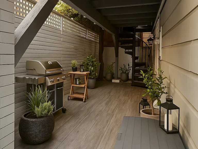 Backyard space with room for BBQ grill and more, with spiral staircase access to upper deck