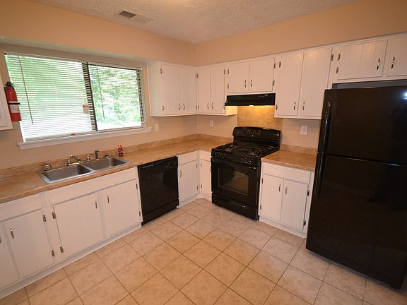 Big beautiful kitchen space with black appliances