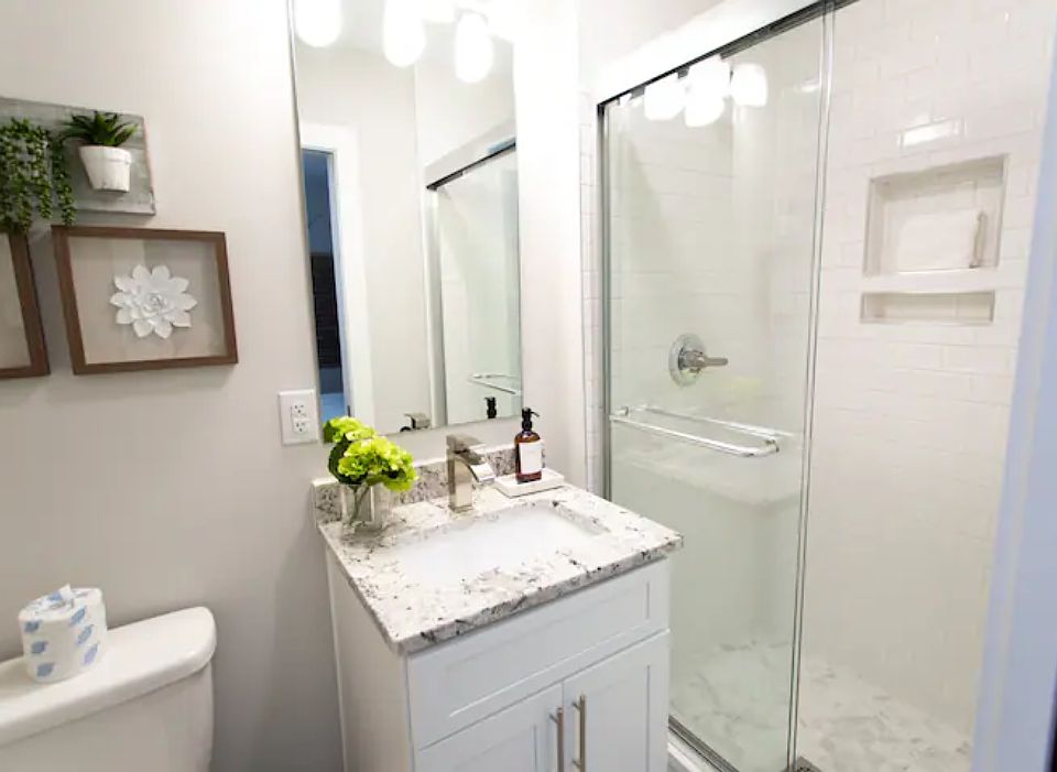 First-Floor Bathroom: Bright, modern bath with granite vanity and walk-in shower.
