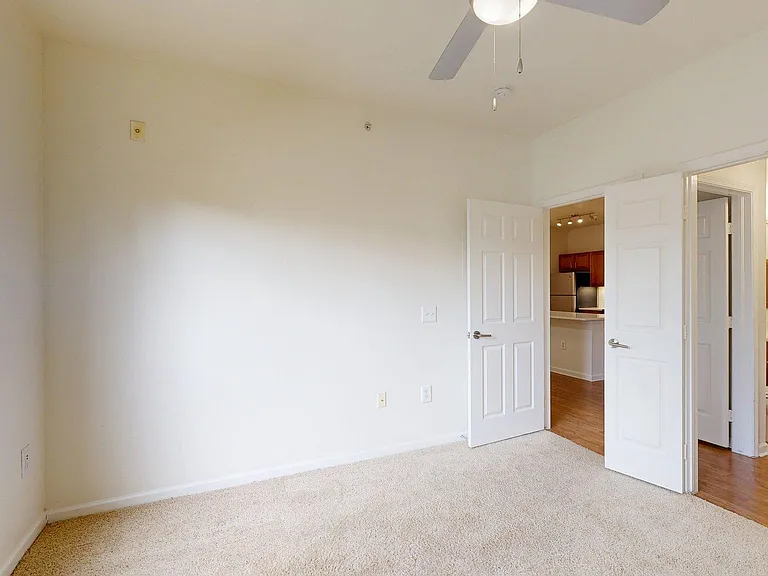 Spacious apartment Bedroom with Attached Bathroom and carpet floors.