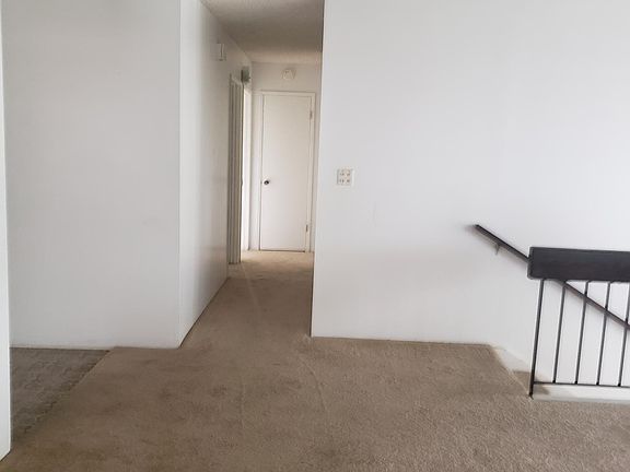 Dining room and hallway to three bedrooms and a bathroom