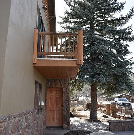 North facing balcony, east facing entry and 45 year old blue spruce that is about 50 feet tall.
