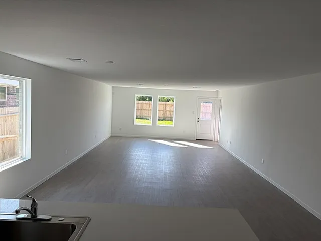 Open concept view from the kitchen to the dining area and family area.