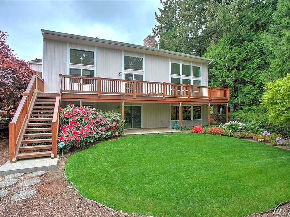 Manicured back yard with mature landscaping; enjoy the spacious deck with views of the golf course!