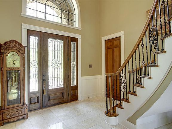  Marble floor entry and lead glass door with transom and lead glass sidelights.