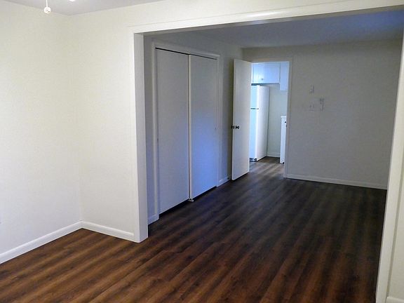 Bedroom showing closet and door to kitchen.