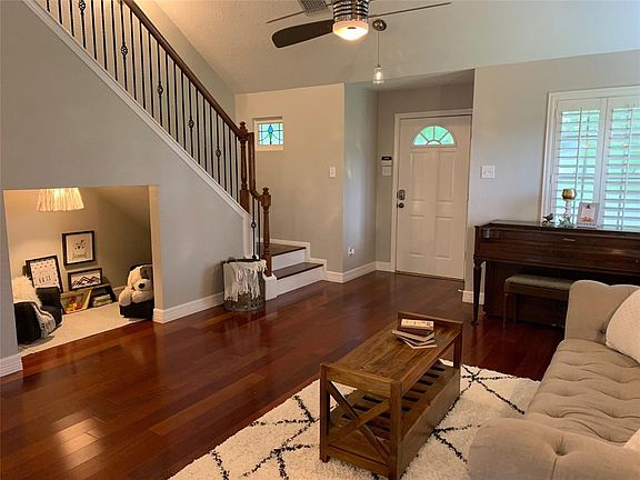 This home has a kids playroom under the stairs. You could put doors on it and use it for storage, if you prefer. Brazilian cherry hardwoods, wrought iron stair railings, plantation shutters, recent ceiling fan and stained glass window are featured in