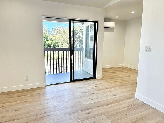 Looking from the living room into the dining area with in wall AC/heating unit