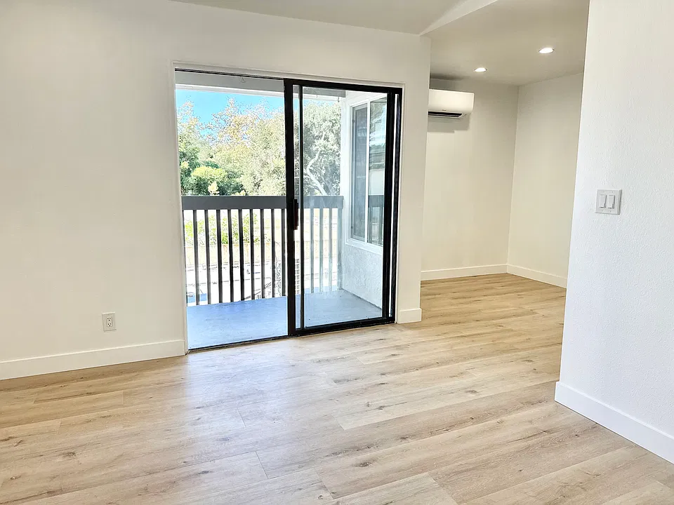 Looking from the living room into the dining area with in wall AC/heating unit