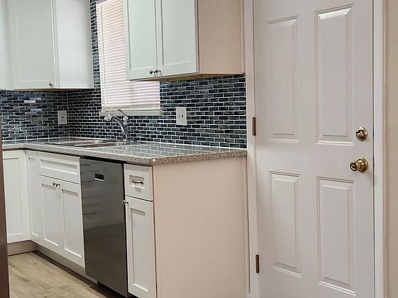 Newly Updated Kitchen - Lots of cabinet space, Counter tops, tile backsplash, window over sink area. All appliances are included. Side-by-side fridge with water/ice maker in the door.