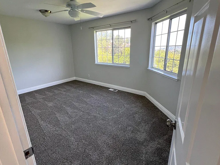 Large upstairs bedroom with ceiling fan, built in lighting, 2 bright windows