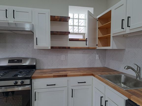 Custom butcherblock countertops and shelving, with under cabinet light