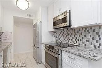 Pasta arm over electric, smooth-top range.