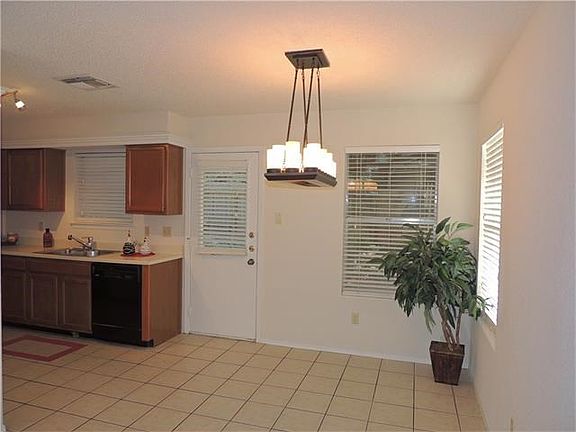 Dining area open to kitchen and looks out to shaded back lawn