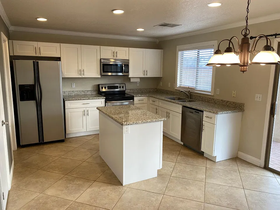 Newly updated kitchen with Shaker cabinets and granite countertops.