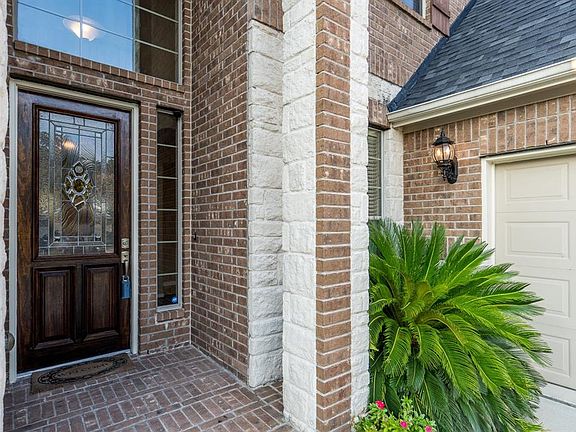 Beautiful leaded glass frontdoor and transom for extranatural light inside.