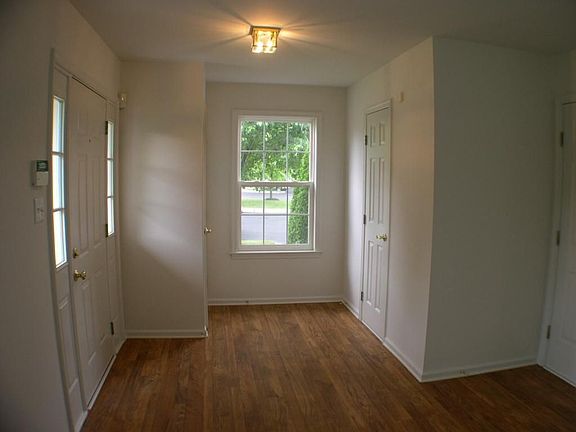 Bright and airy foyer entrance with hall closet, powder room