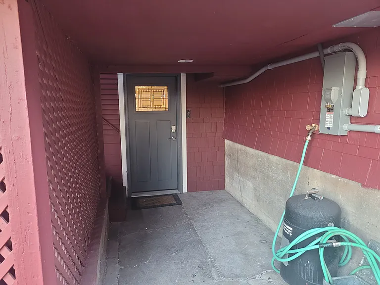 Door leading to the shared laundry and back entrance of 229.