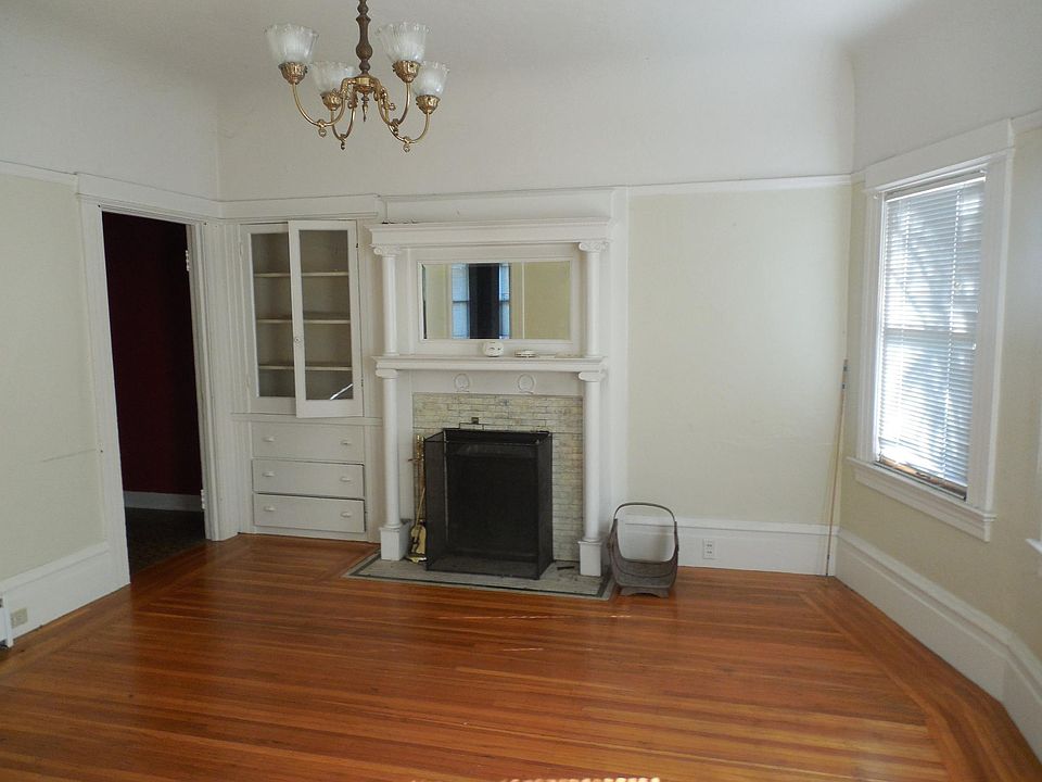 Living room with fireplace (aesthetic only); oak floors; cove ceilings; bay window
