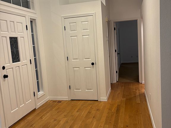 Front entry with entry closet. Looking down hall to main bedroom.