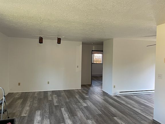 Picture from front door into living room-kitchen/dining area/back door to fenced in yard to right-straight forward 2nd bedroom and access to 1rst bedroom left and bathroom right
