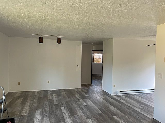 Picture from front door into living room-kitchen/dining area/back door to fenced in yard to right-straight forward 2nd bedroom and access to 1rst bedroom left and bathroom right