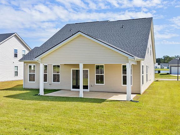 Spacious rear exterior with a covered porch, perfect for outdoor living in Chestnut Farms.