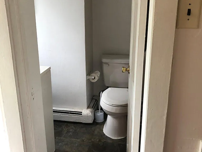 Bathroom with vintage medicine cabinets, shower/tub combo and vanity with storage space.