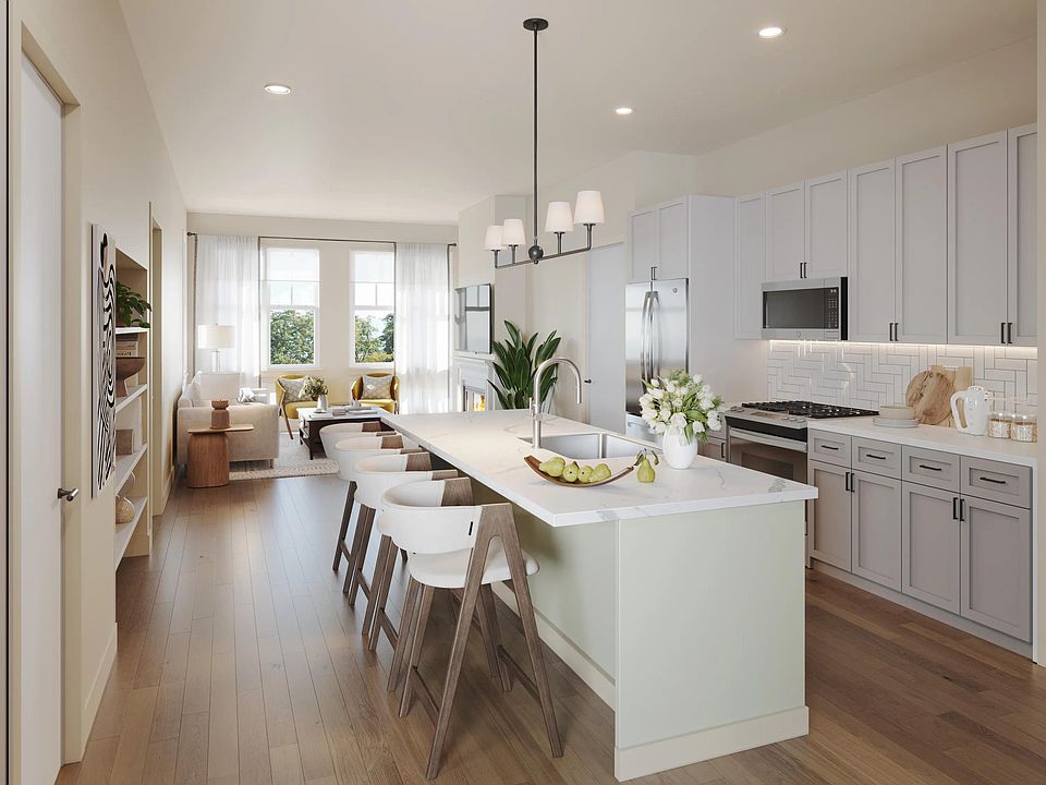 Our kitchens feature with shaker-style cabinetry, quartz countertops, a large island with seating, and stainless steel appliances.