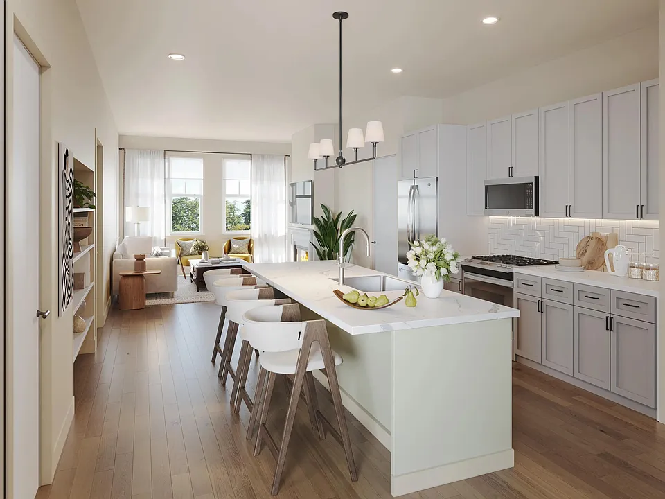 Our kitchens feature with shaker-style cabinetry, quartz countertops, a large island with seating, and stainless steel appliances.
