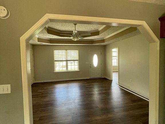 From kitchen looking into living area and front door. New floors and paint.