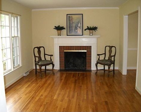 Living room with picture window, refinished hardwoods, gas log fireplace