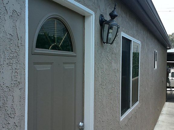 Front door & shot facing alley. This is the last building closest to alley. Security gates.