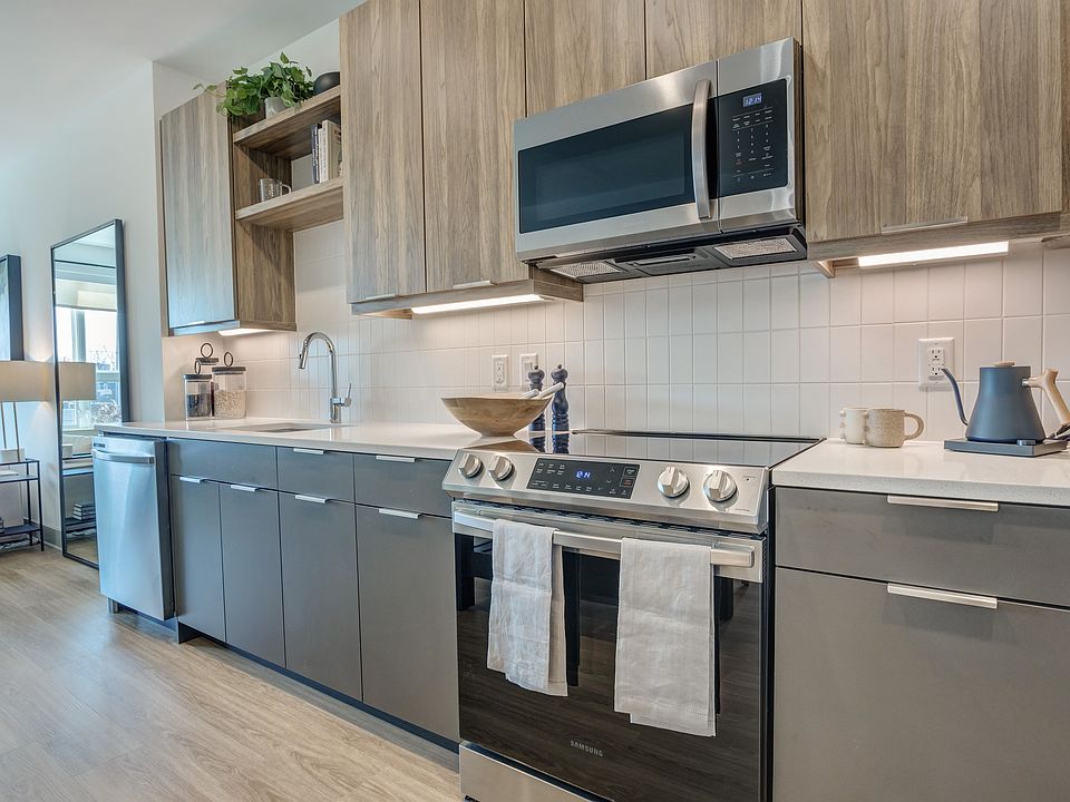 Enjoy a kitchen decked out with gorgeous quartz countertops, custom cabinetry, pendant lighting and Energy Star stainless-steel appliances.