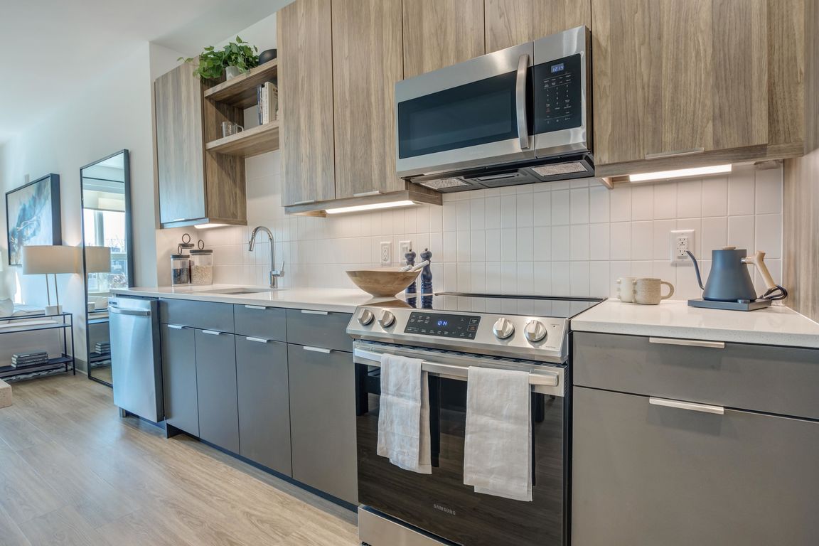 Enjoy a kitchen decked out with gorgeous quartz countertops, custom cabinetry, pendant lighting and Energy Star stainless-steel appliances.