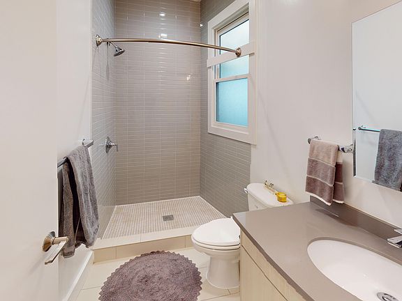 Bathroom with a toilet, sink and walk-in shower