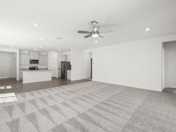 The family room is spacious with a ceiling fan.
