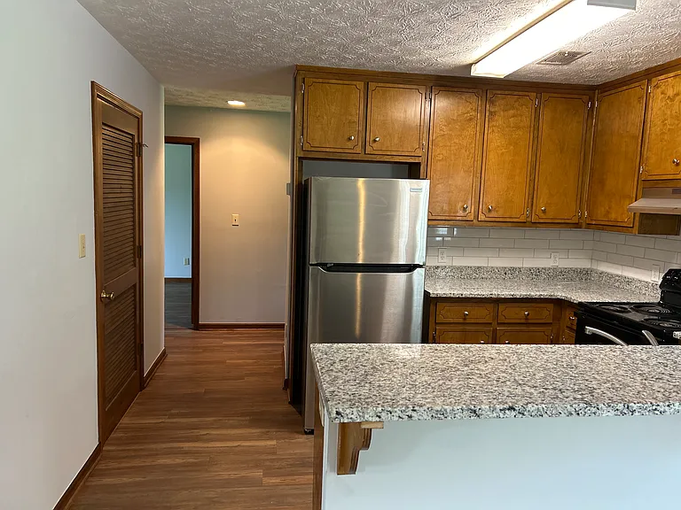 Kitchen has new granite countertops and tile backsplash; new refrigerator.
