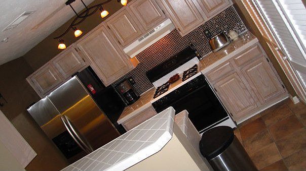 New glass mosaic backsplash, new countertops, light fixtures, and floors