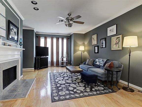Large living area with wood floors and fireplace with gas connection.