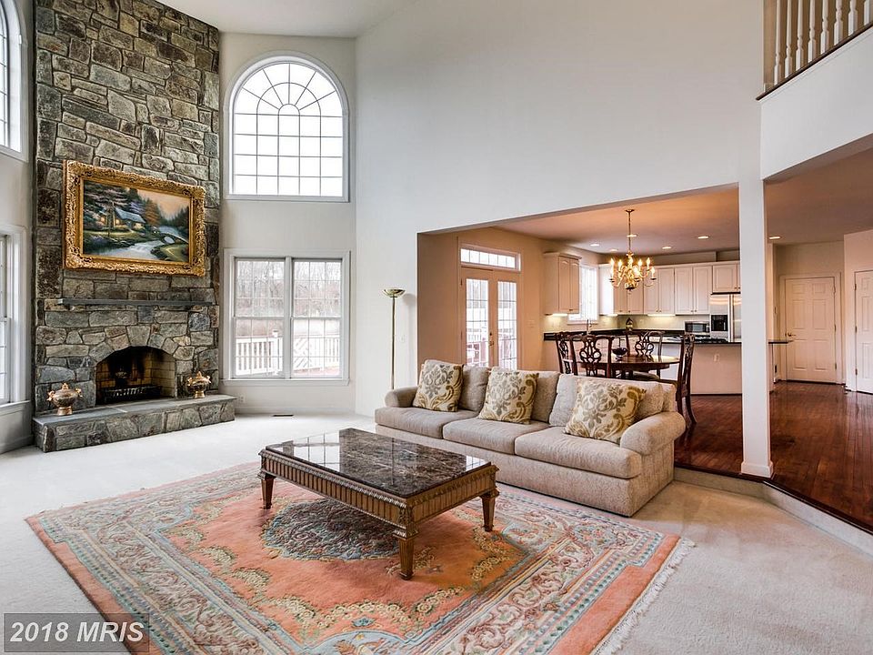 Soaring two story stone fireplace in Family Rm