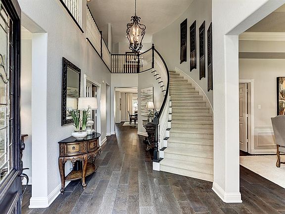 Welcome! How stunning is this foyer? 7 inch matte wood flooring runs through the main living areas for a seamless look.