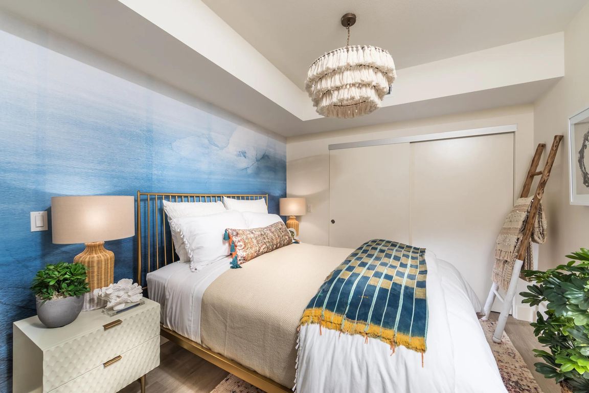 Primary bedroom featuring expansive closet space and spa_inspired bathroom access.