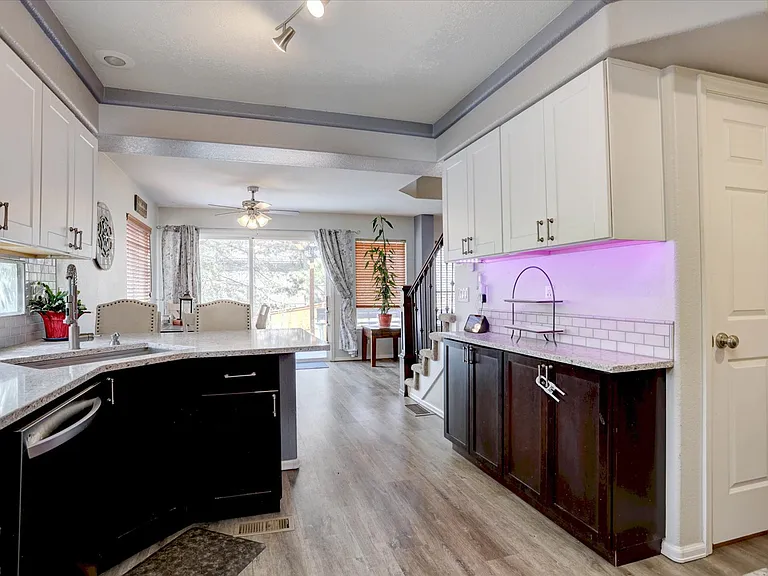 kitchen view towards dining and sliding glass door to backyard