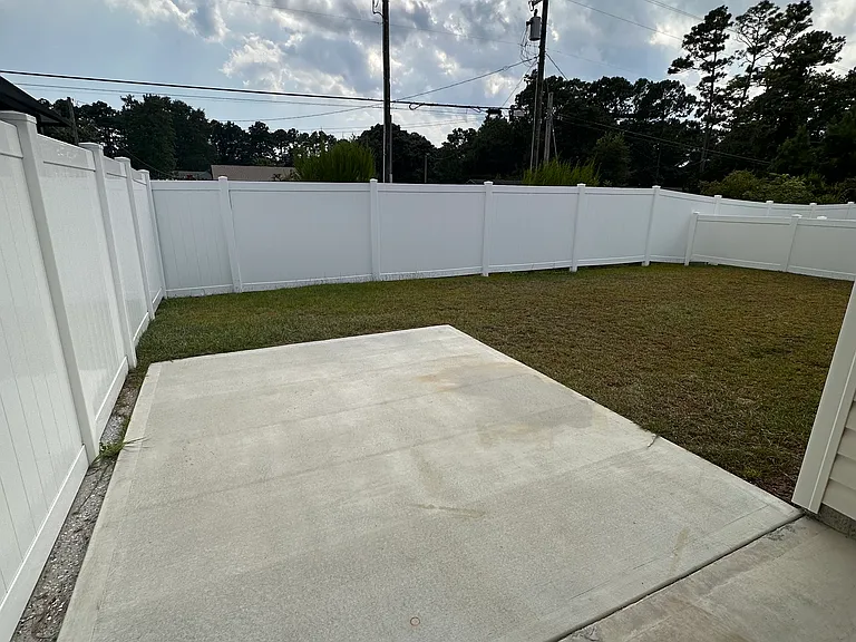 Large cement patio in back yard for gathering space