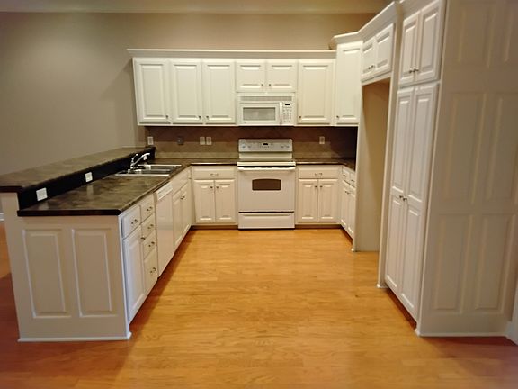 Kitchen w/Stove, Microwave, Dishwasher, and Stainless Steel Double Sink