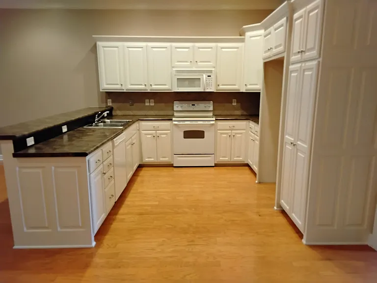 Kitchen w/Stove, Microwave, Dishwasher, and Stainless Steel Double Sink