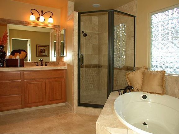 Lovely master bath with travertine, cherry, and lots of tile.  Walk-in closet.