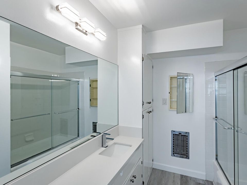 WOW! Check out this bathroom. With heater, cabinet space and bathtub.
